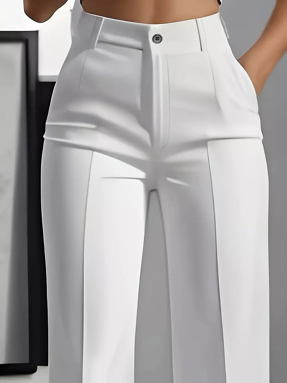 Close-up of the white dress pants button waist and front crease