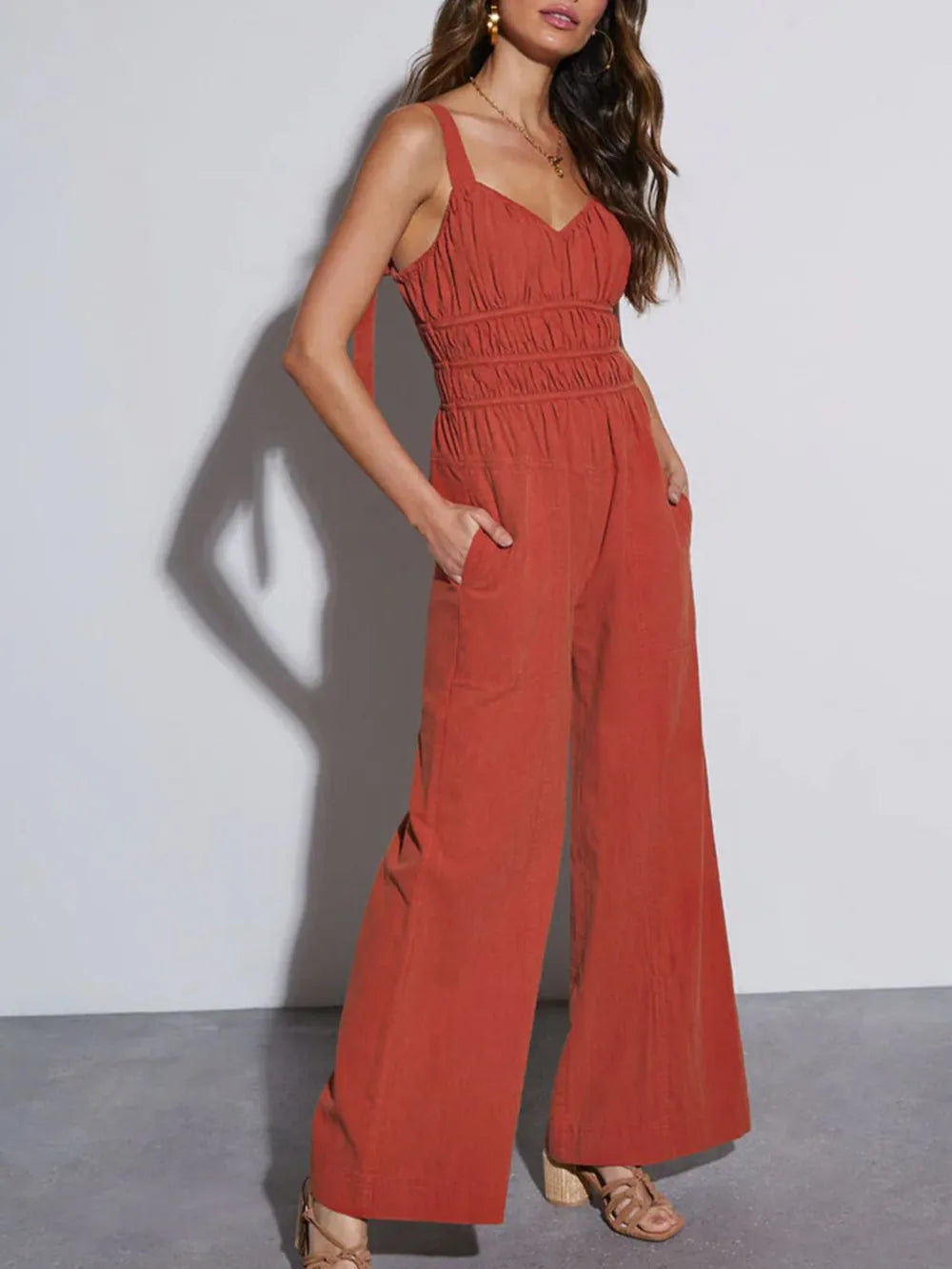 Women's wide leg jumpsuit in rust, ruched smocked bodice with tie back, front view