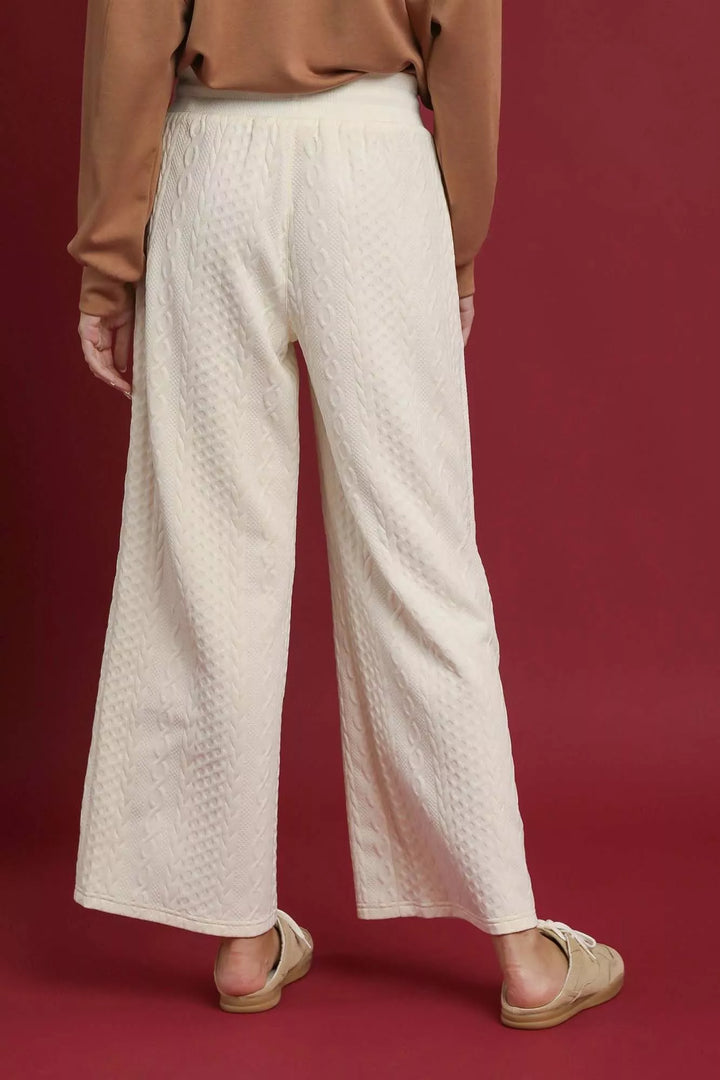 Back view of the ivory ankle length wide leg pants