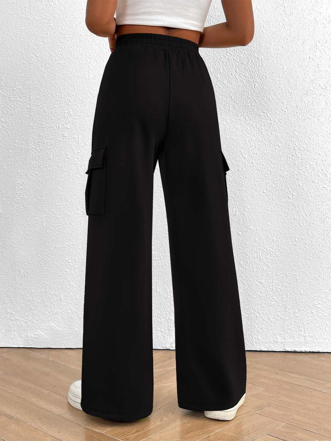 Back view of the women's black high waisted wide leg cargo pants