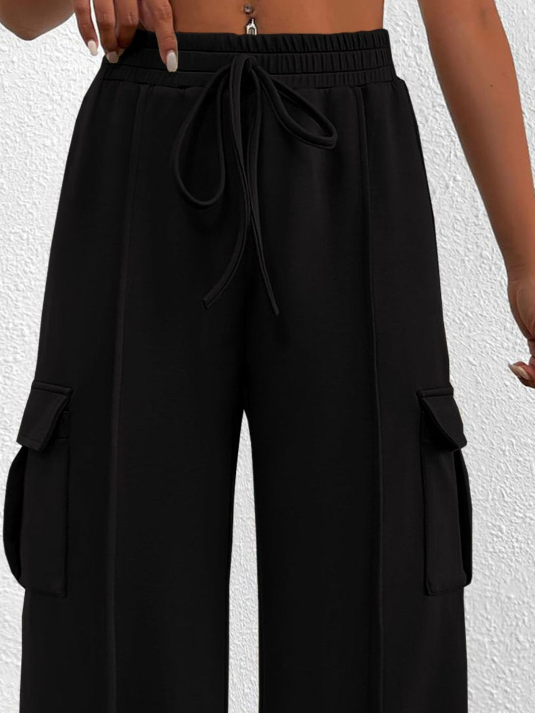 Close-up of the women's black cargo pockets and drawstring waist