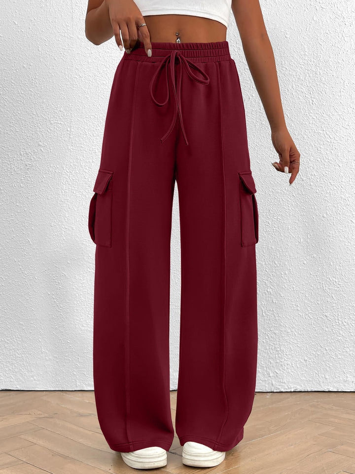 Burgundy wide leg cargo pants with high waist and drawstring, front view