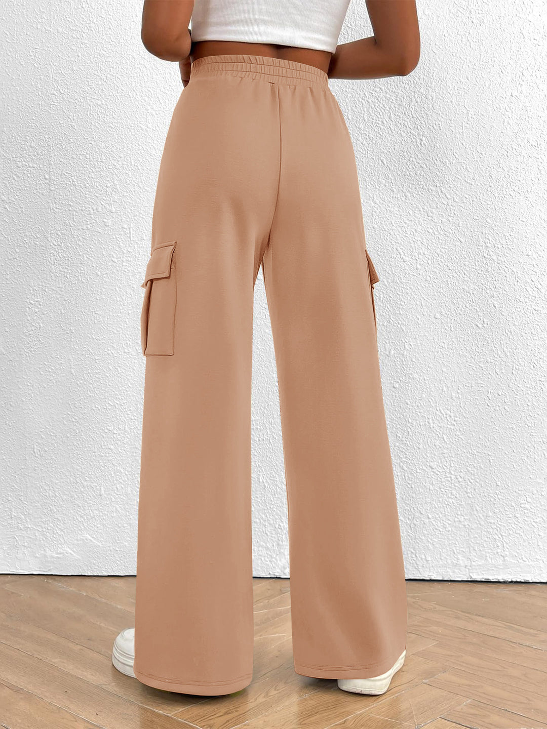Back view of the women's peach high waisted wide leg cargo pants