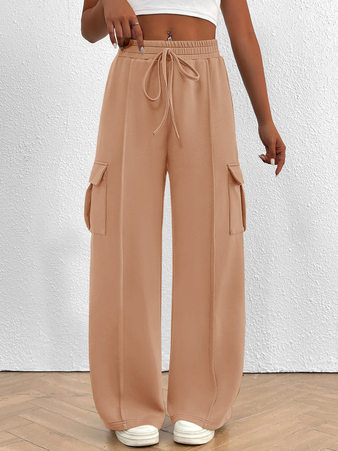 Peach wide leg cargo pants with high waist and drawstring, front view