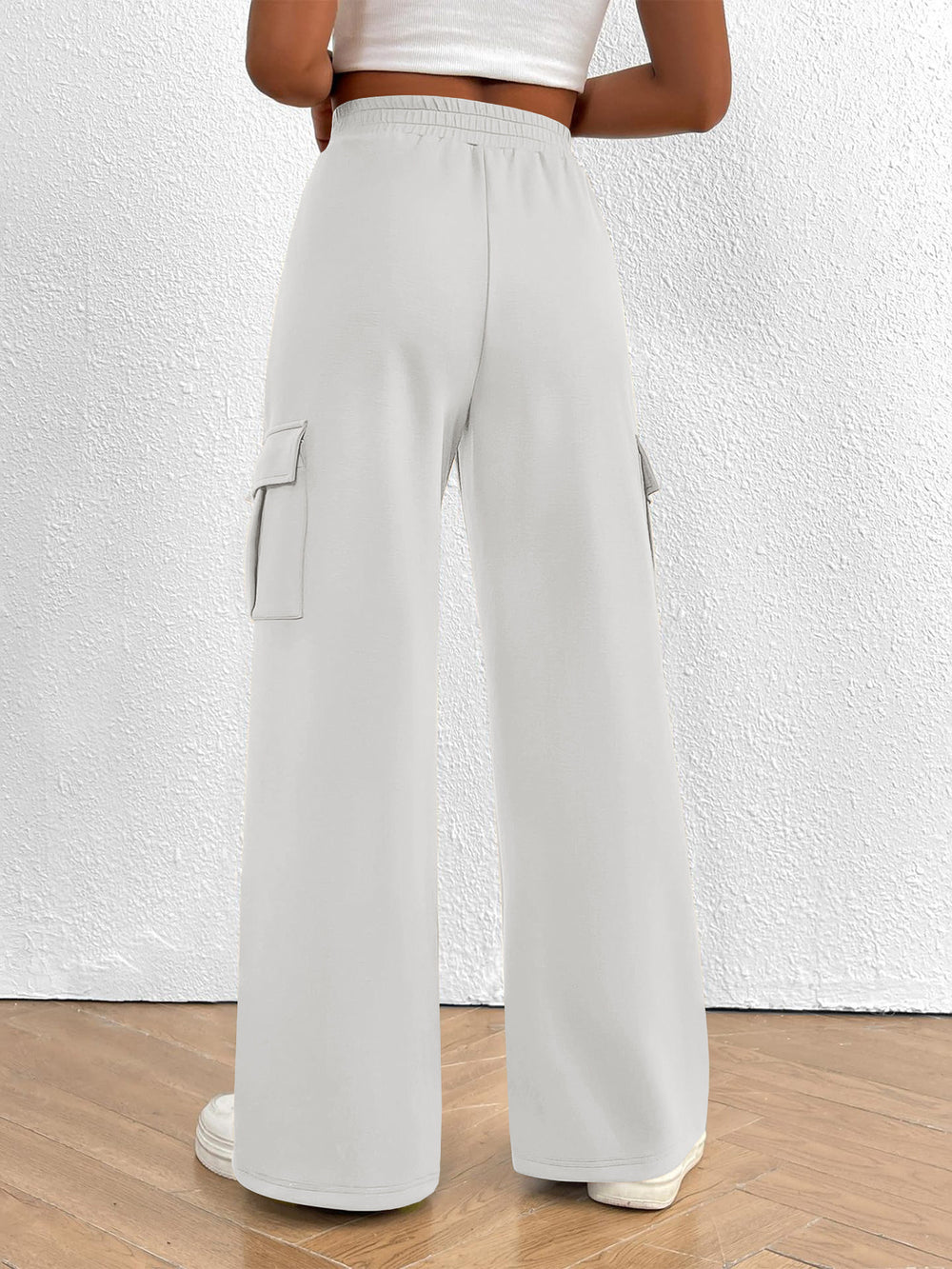 Back view of the women's white high waisted wide leg cargo pants