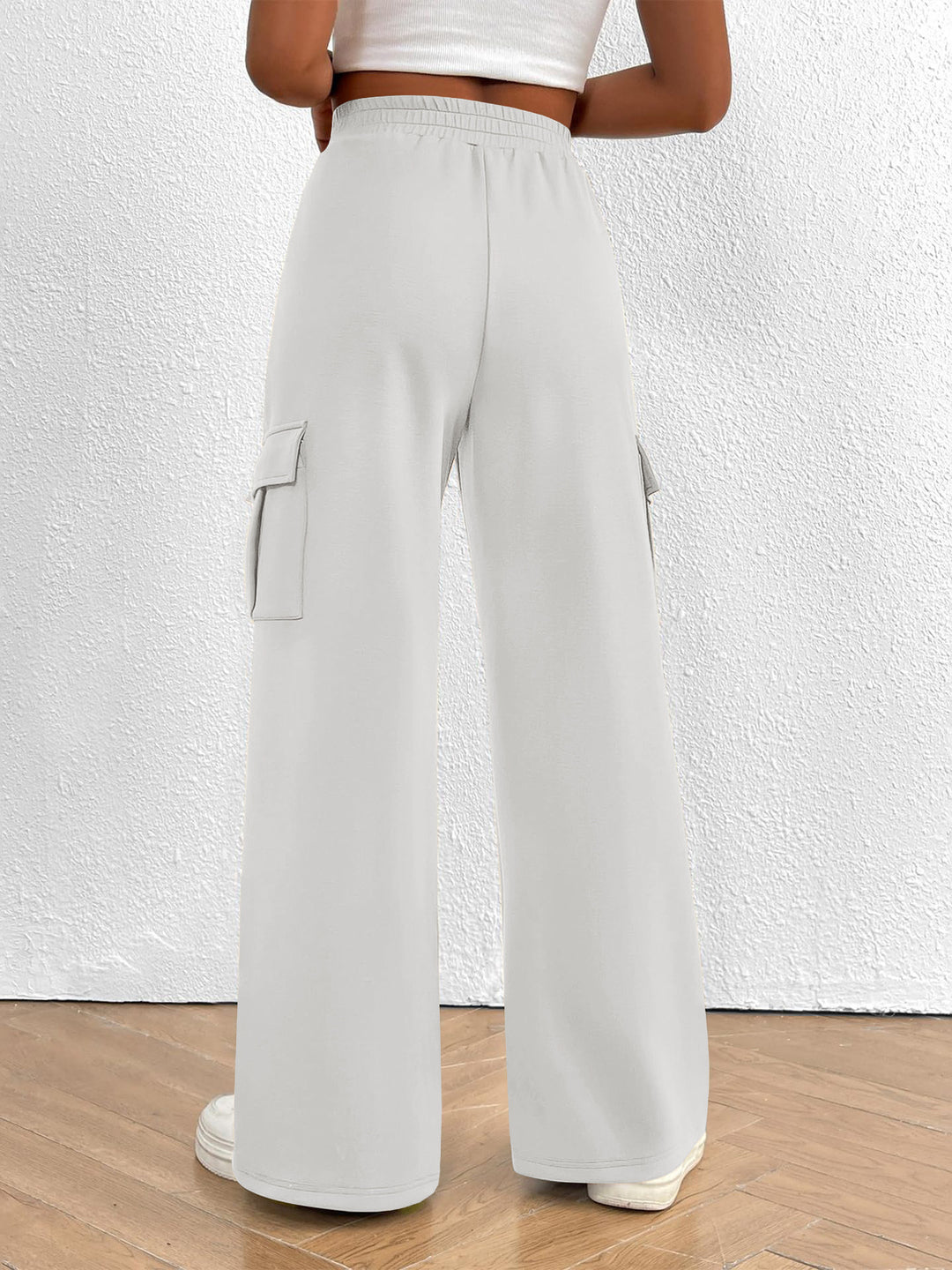 Back view of the women's white high waisted wide leg cargo pants