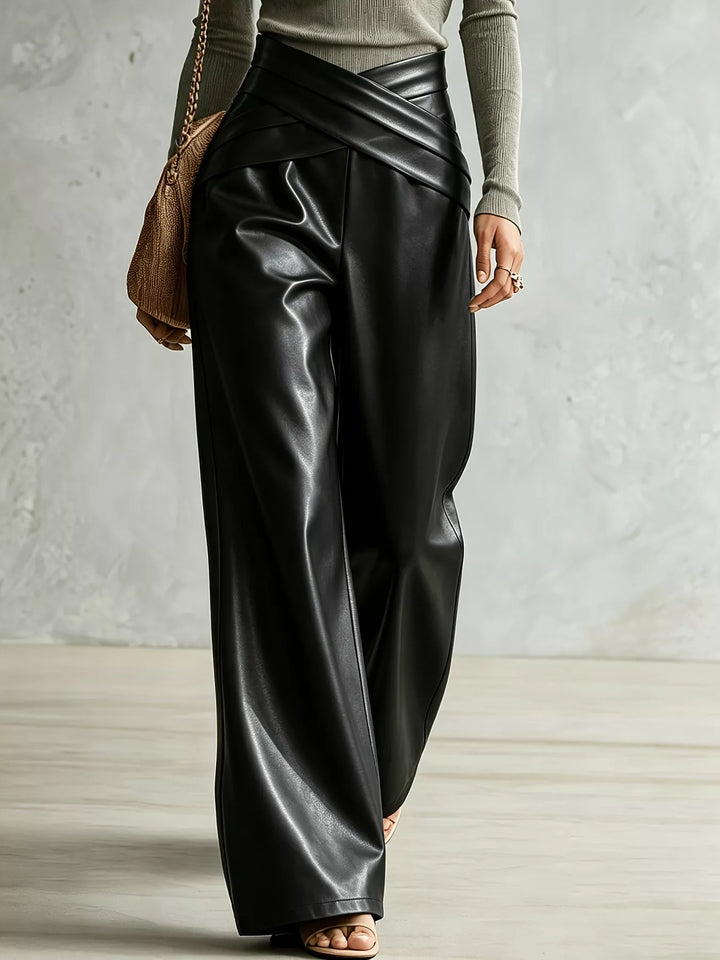 Black high shine wide leg pants in a walking pose, angled view