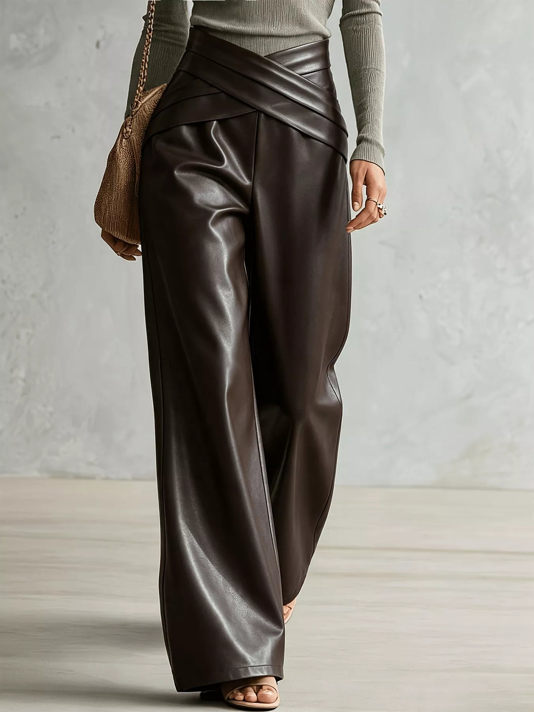 Brown high shine wide leg pants captured mid-step from the side