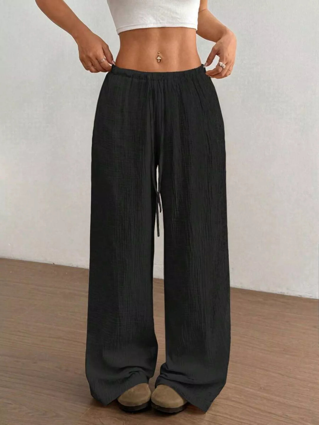 Black wide leg pants with drawstring waist, front view with cropped white top