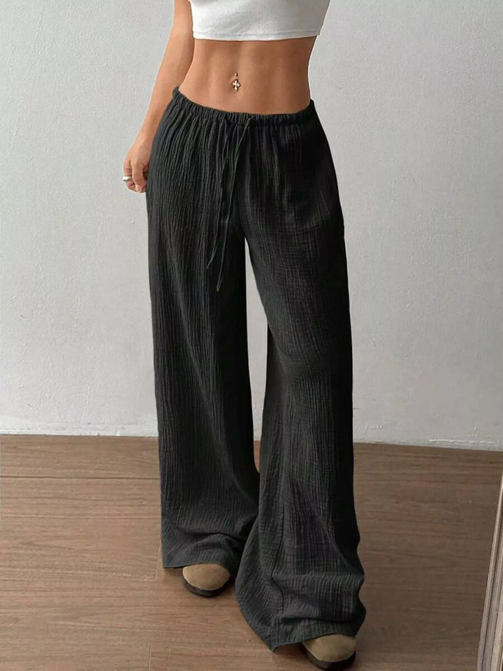Side angle of the black drawstring wide leg pants
