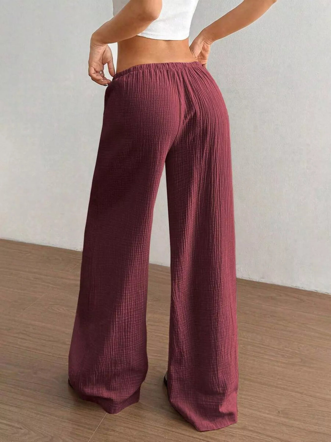 Back view of the burgundy wide leg pants with elastic waistband