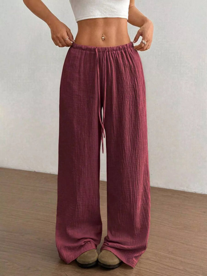Burgundy wide leg pants with drawstring waist, front view with cropped white tee