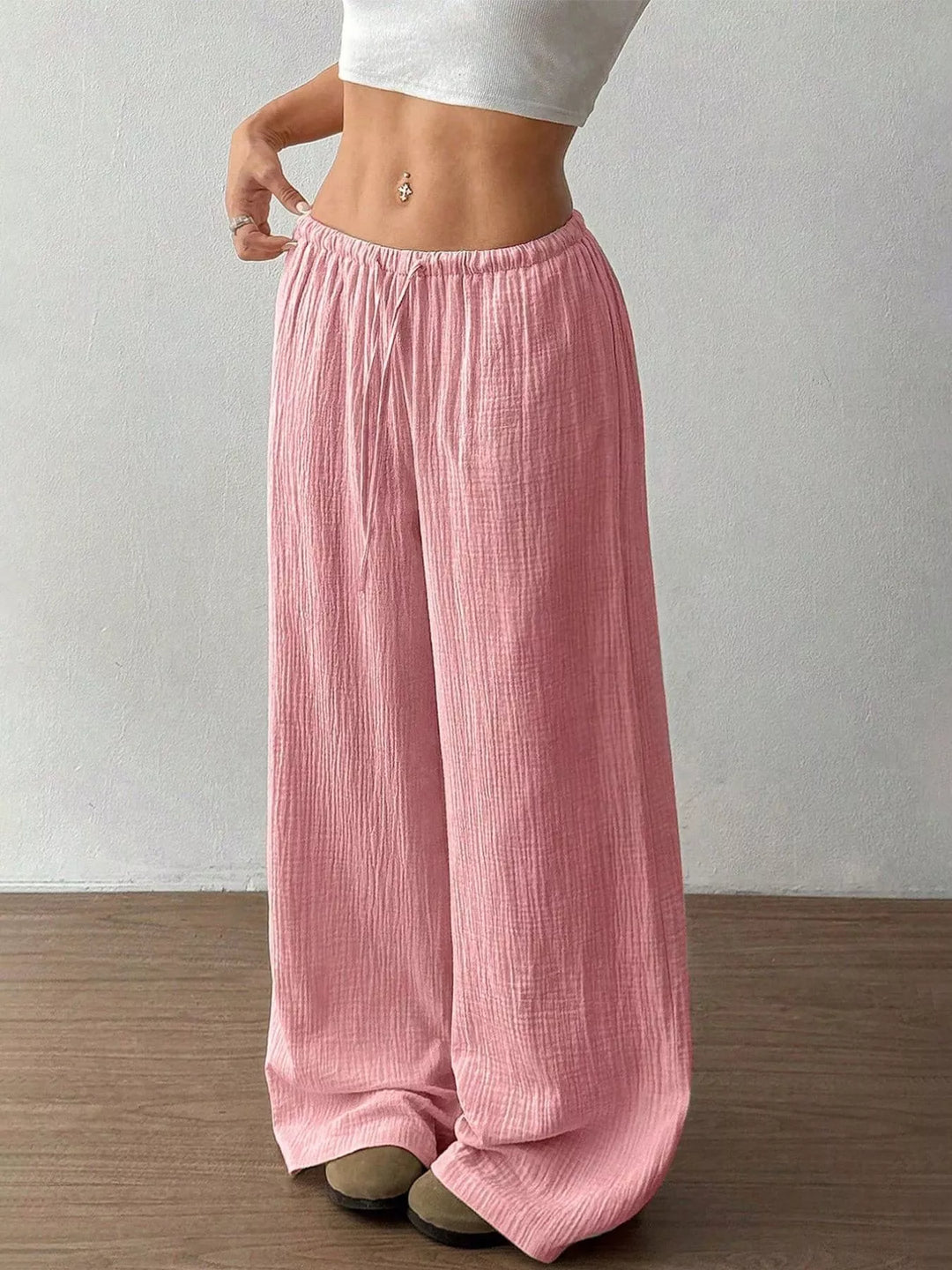 Side view of the pink drawstring wide leg pants in a relaxed fit