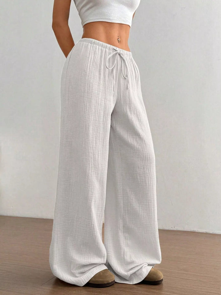 Back view of the white crinkled wide leg pants with elastic waist