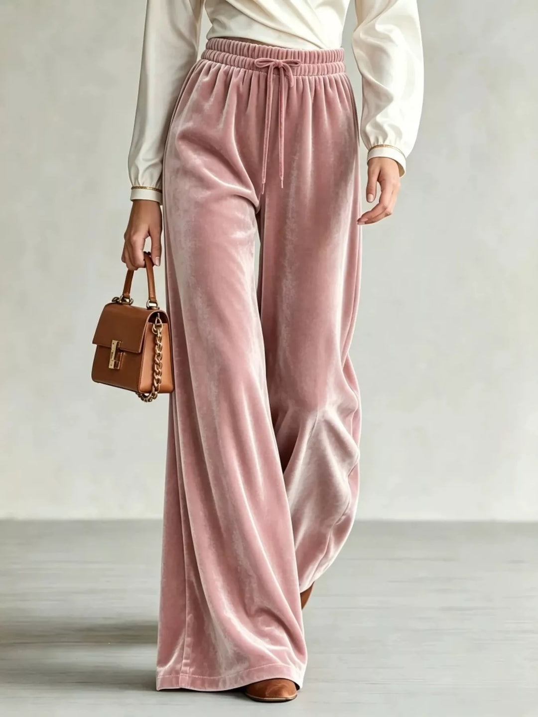 Women's dusty pink wide leg pants, drawstring velvet-look soft pile, with a brown handbag