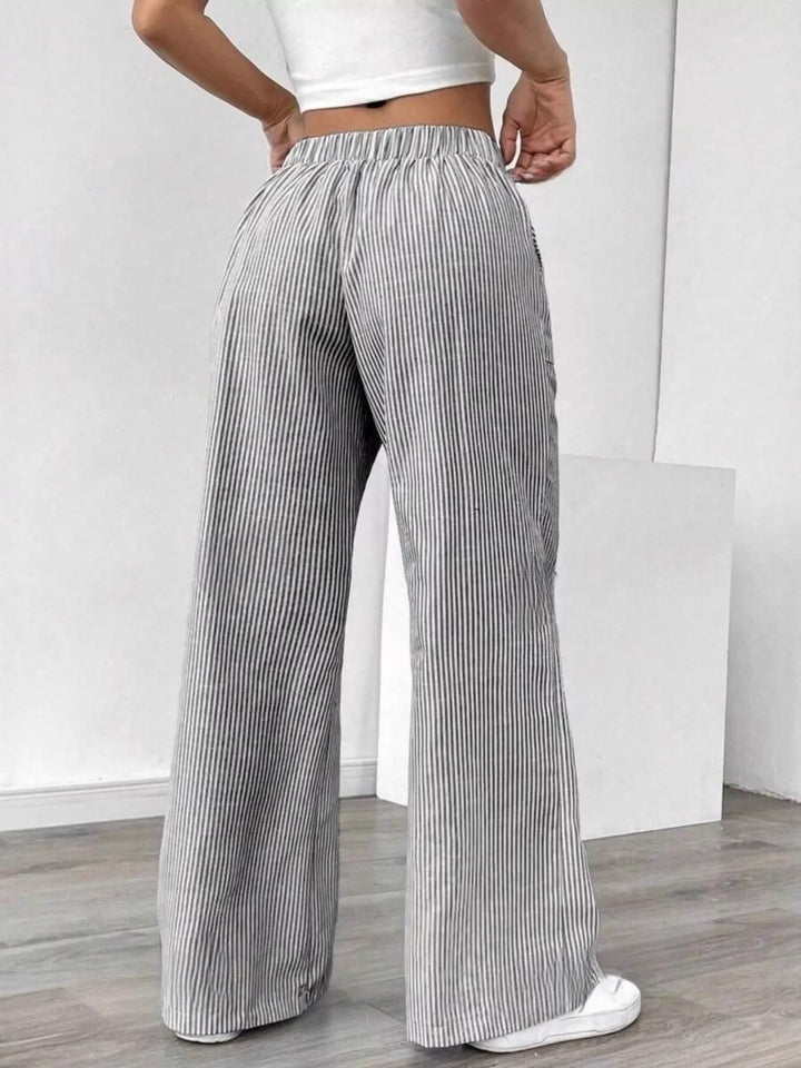 Back view of the light gray fine stripe wide leg pants with elastic waist