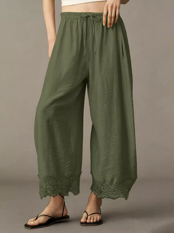 Army green pants with sandals showing the lace trim along the hem