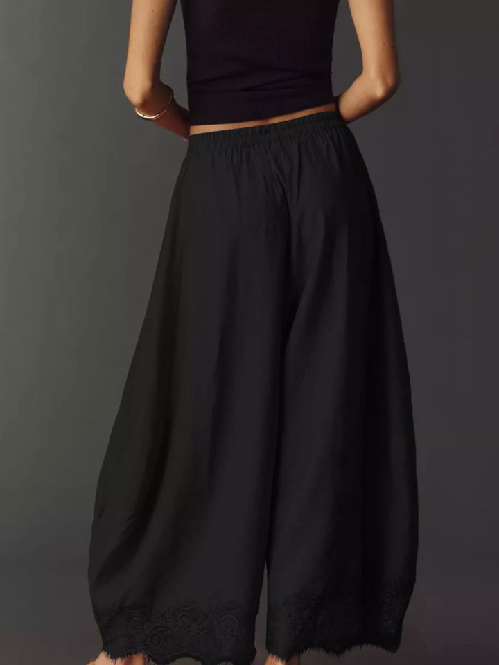 Black wide leg pants from behind with flowing legs