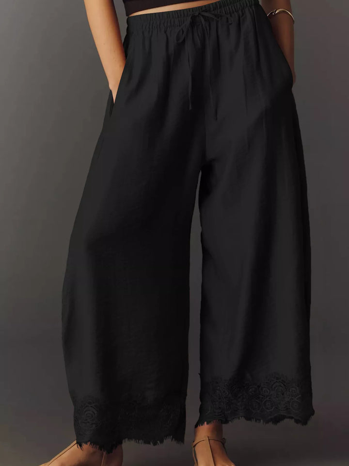 Black wide leg pants front view with drawstring waist and lace trim