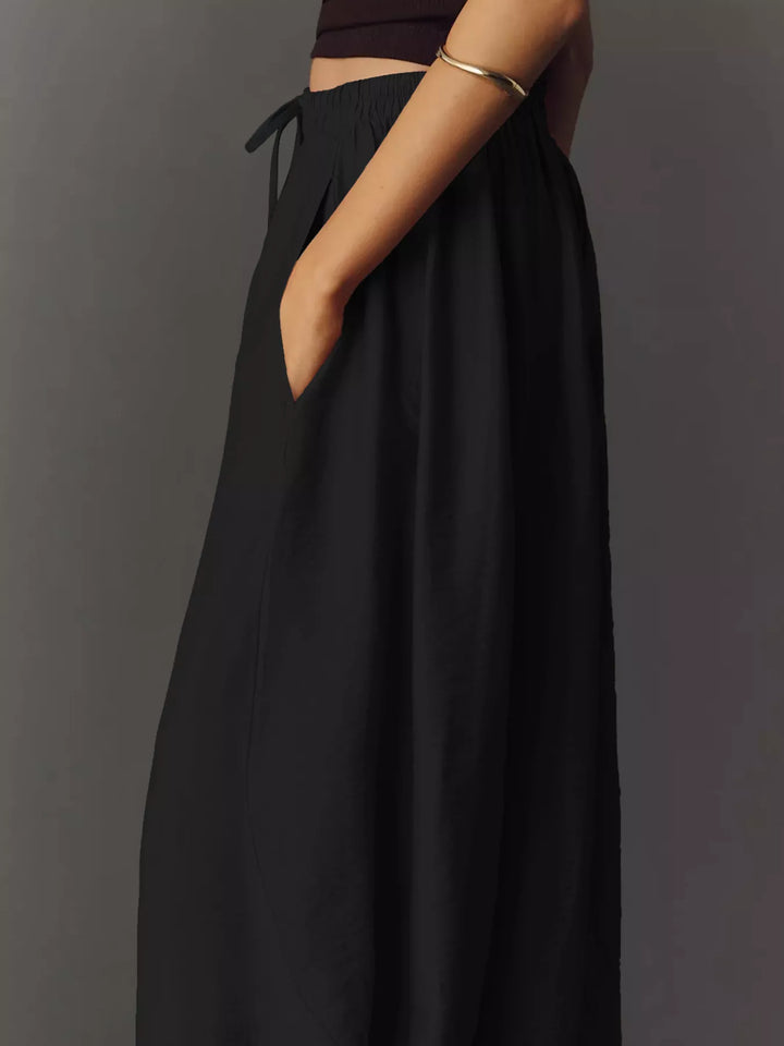 Side view of the black wide leg pants with pocket and relaxed leg