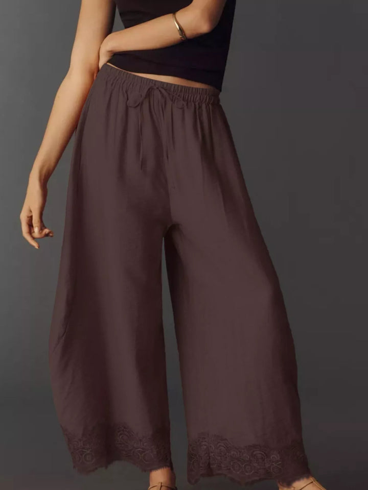 Chocolate drawstring pants from a three quarter angle with lace trim