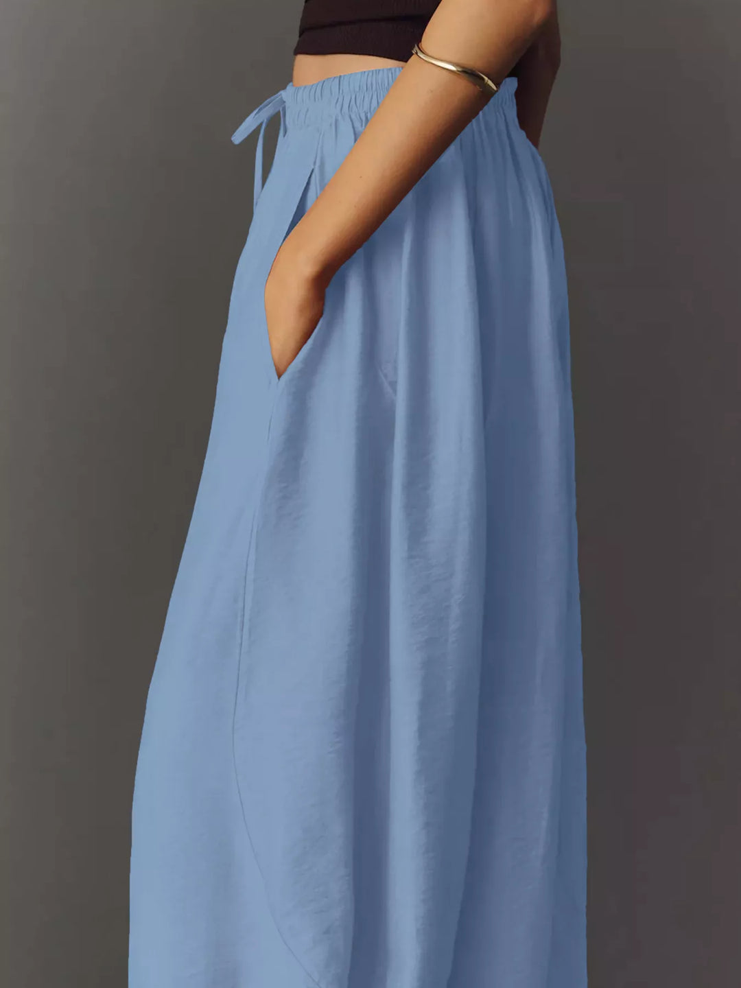 Light blue wide leg pants from the side showing the roomy leg and tie