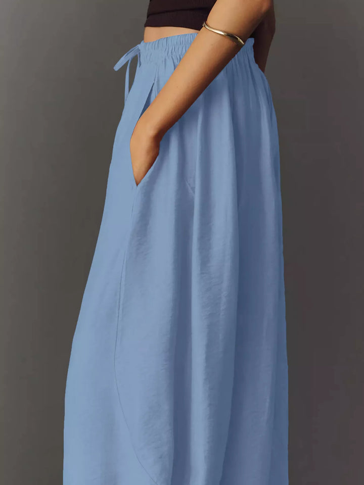 Light blue wide leg pants from the side showing the roomy leg and tie