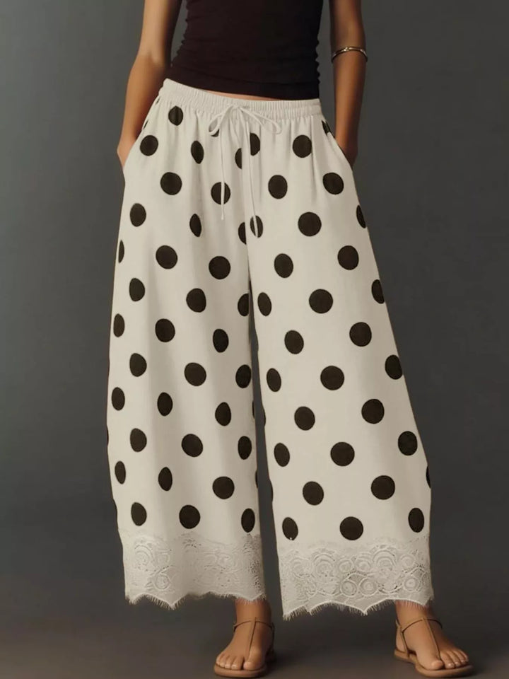 Polka dot wide leg pants in cream with black dots, front view with lace hem