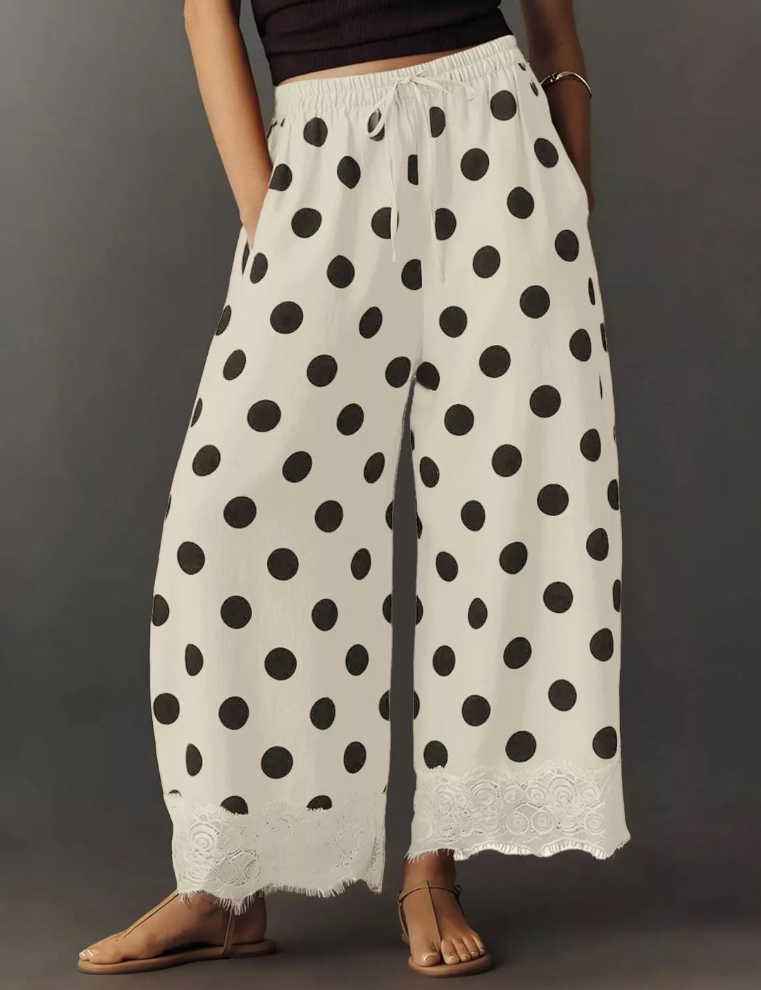 Polka dot drawstring pants from the side with scalloped lace edge
