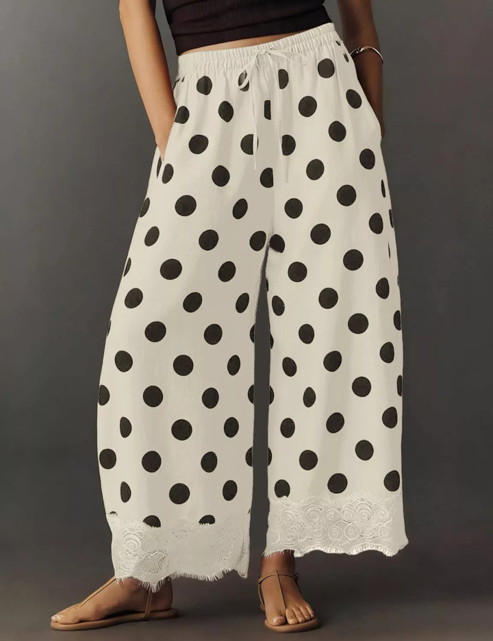 Polka dot drawstring pants from the side with scalloped lace edge