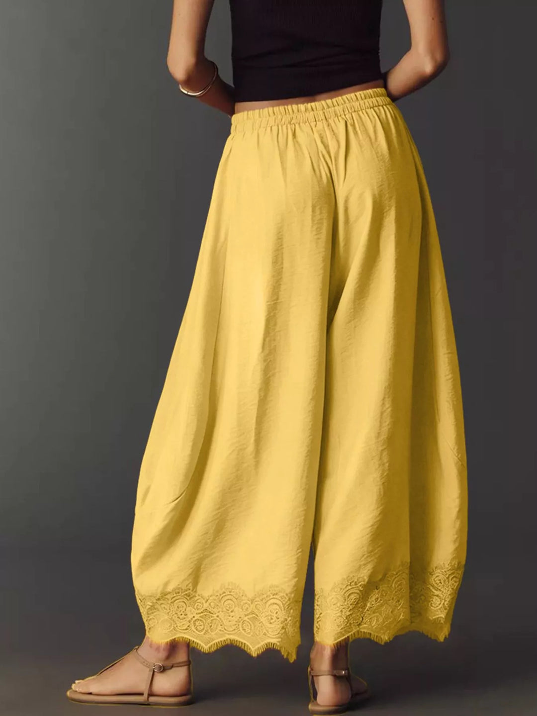 Yellow wide leg pants front view showing the full leg and scalloped hem