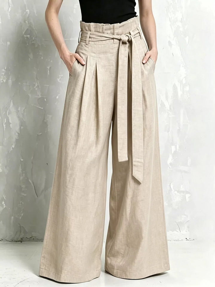 Beige high waist paperbag pants with tied belt and front pleats
