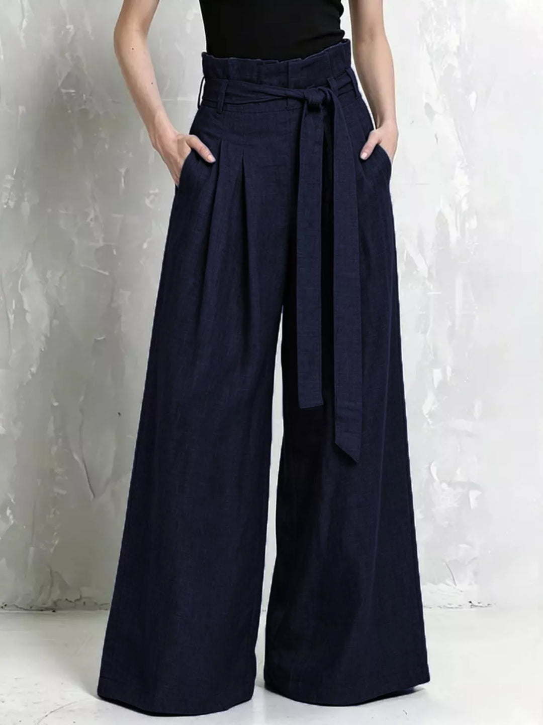 Navy high waist wide leg pants with belt tied at the paperbag waist