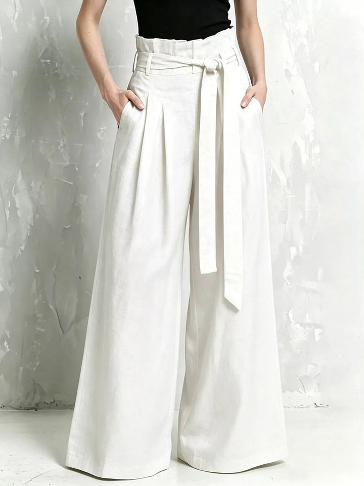 White wide leg pants with paperbag waist, tie belt and pleats, front view
