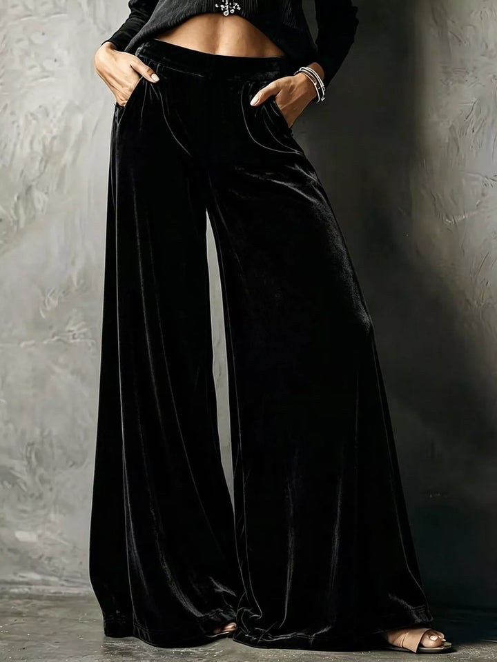 Black high waisted wide leg pants with a shiny velvet-look finish