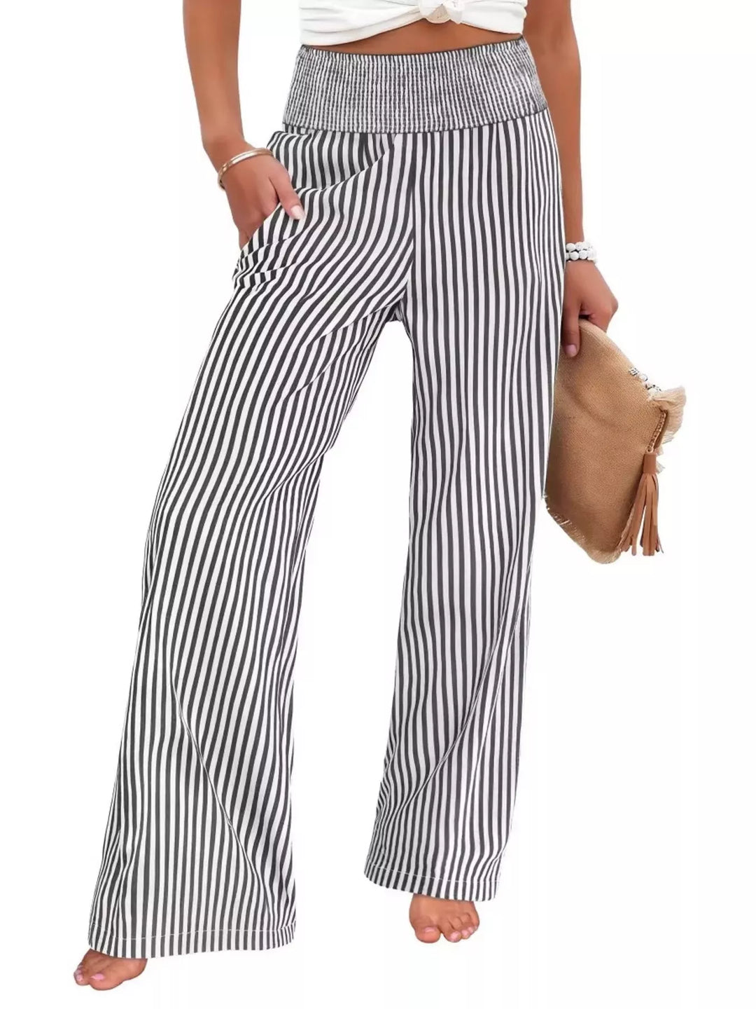 Black striped high waisted wide leg pants with a clutch, front view on white