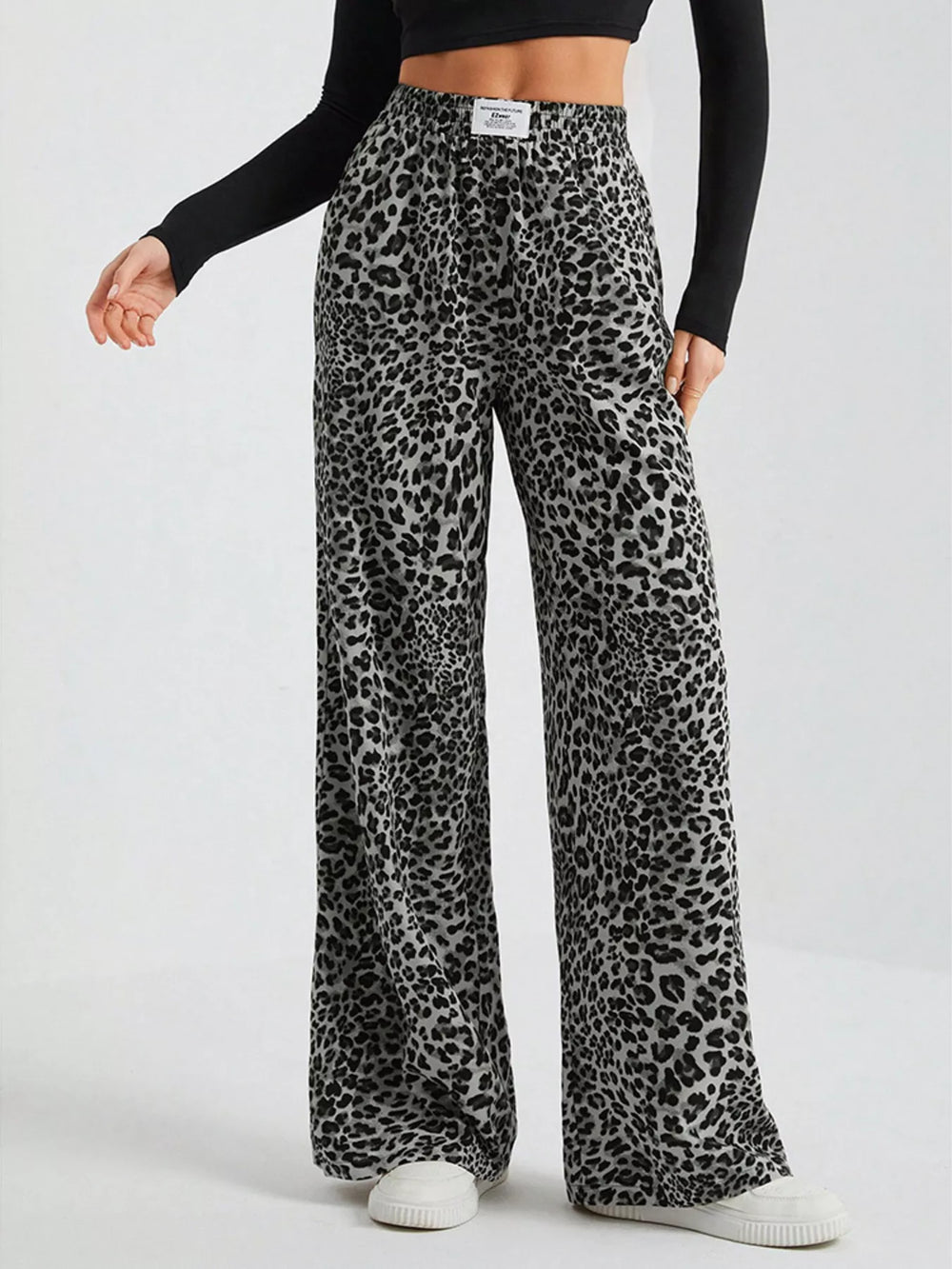 Gray leopard print wide leg pants with elastic waist and white sneakers