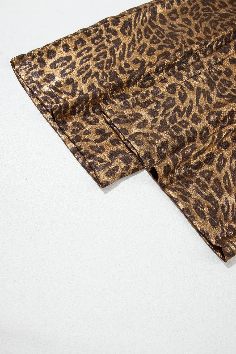 Close-up of the wide leg hem on the metallic leopard print pants