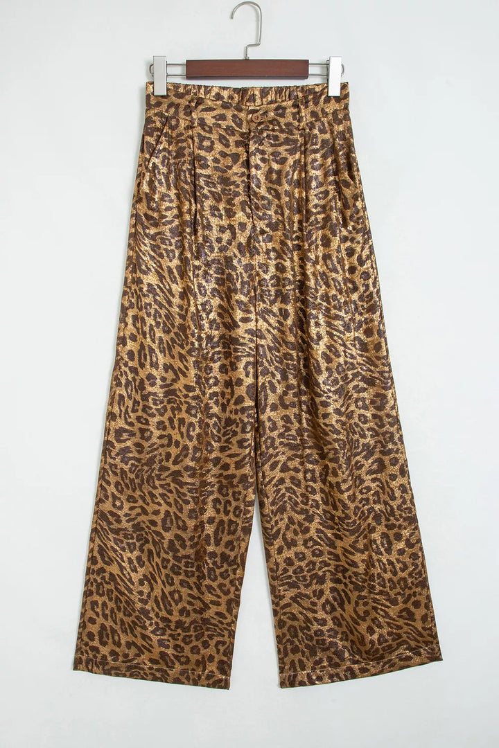 Leopard print wide leg pants hanging, front view on light backdrop