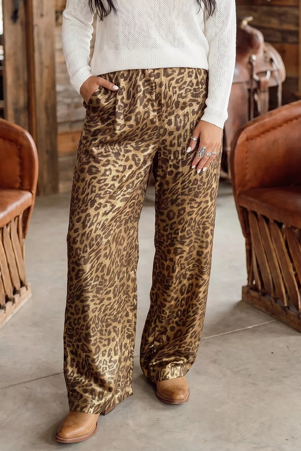 Leopard print wide leg pants styled with a cream sweater and tan boots
