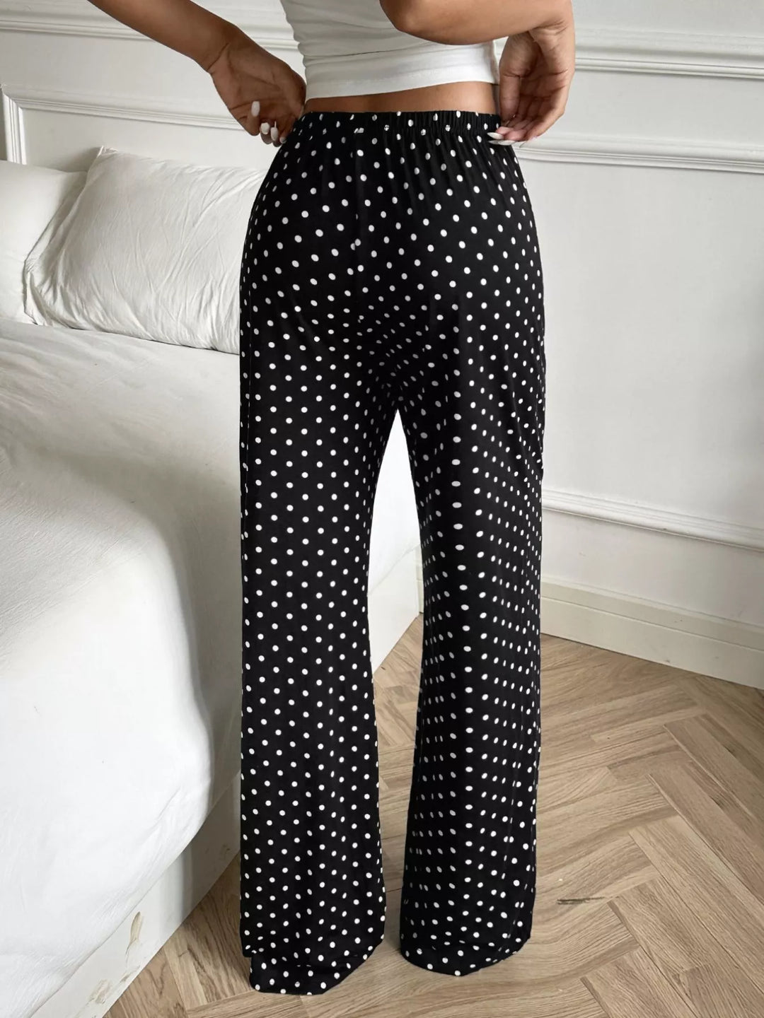 Back view of the black polka dot wide leg pants with an elastic waist