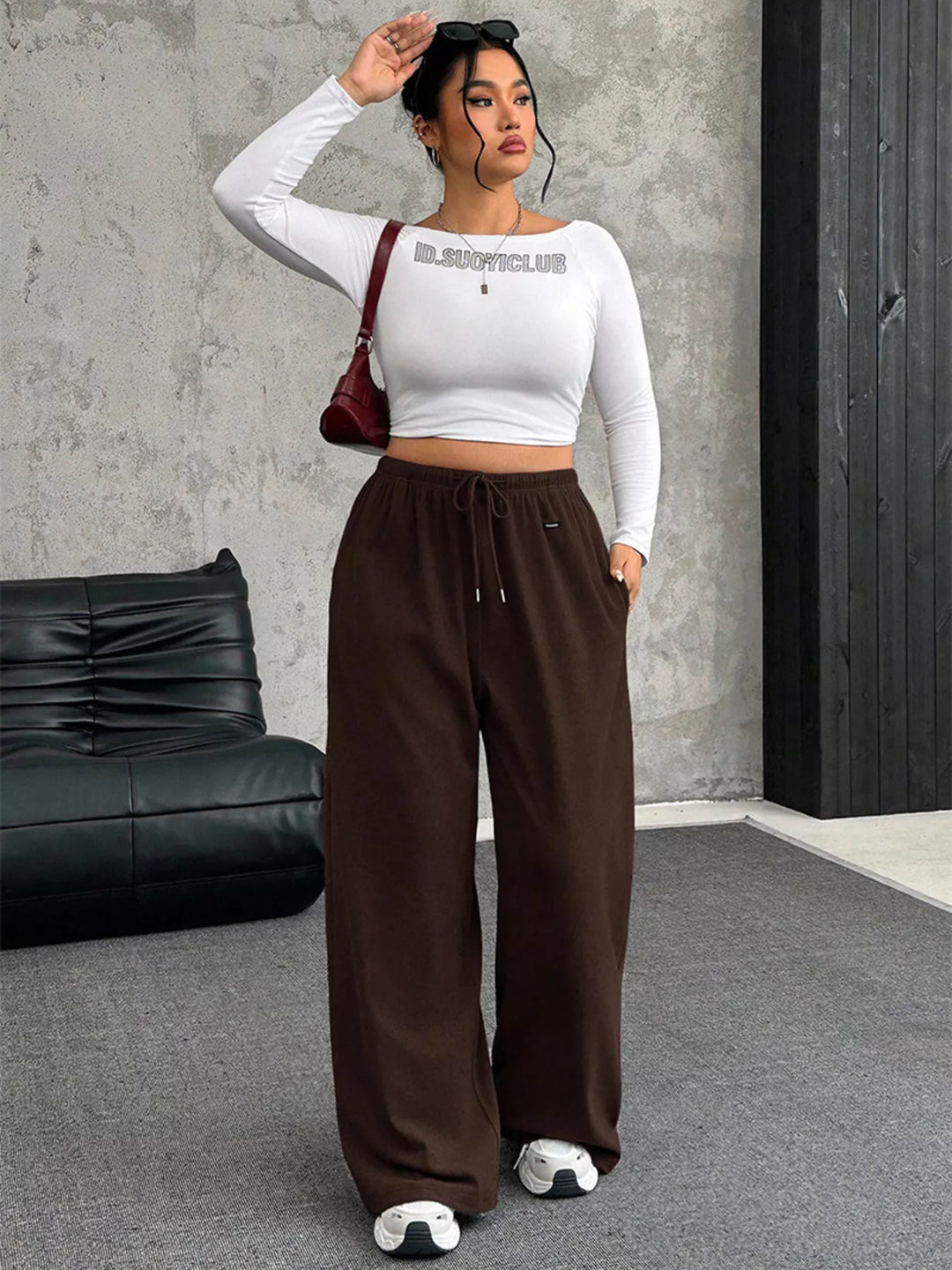 Brown ribbed wide leg pants styled with a white long sleeve crop top