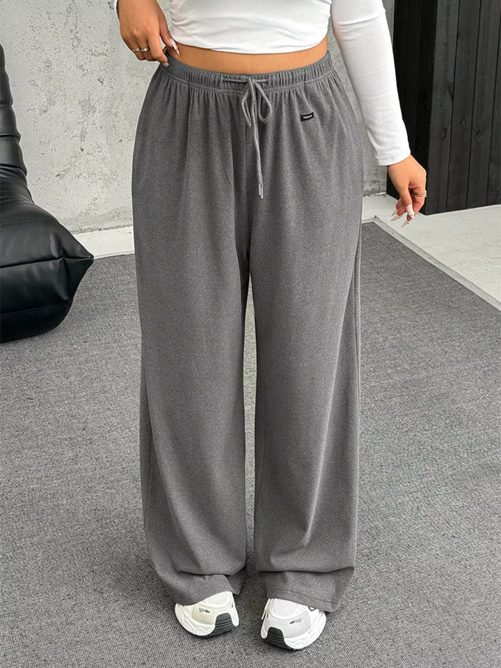 Full length gray wide leg pants with white sneakers