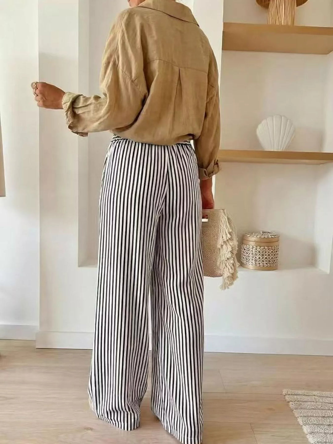Back view of black striped high waisted wide leg pants