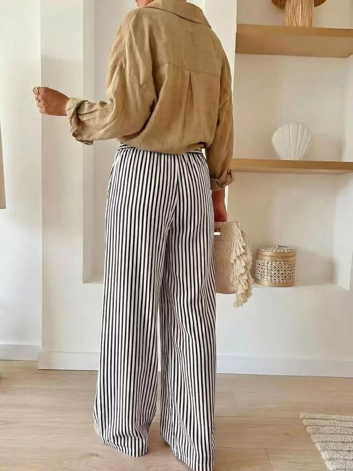 Back view of black striped high waisted wide leg pants