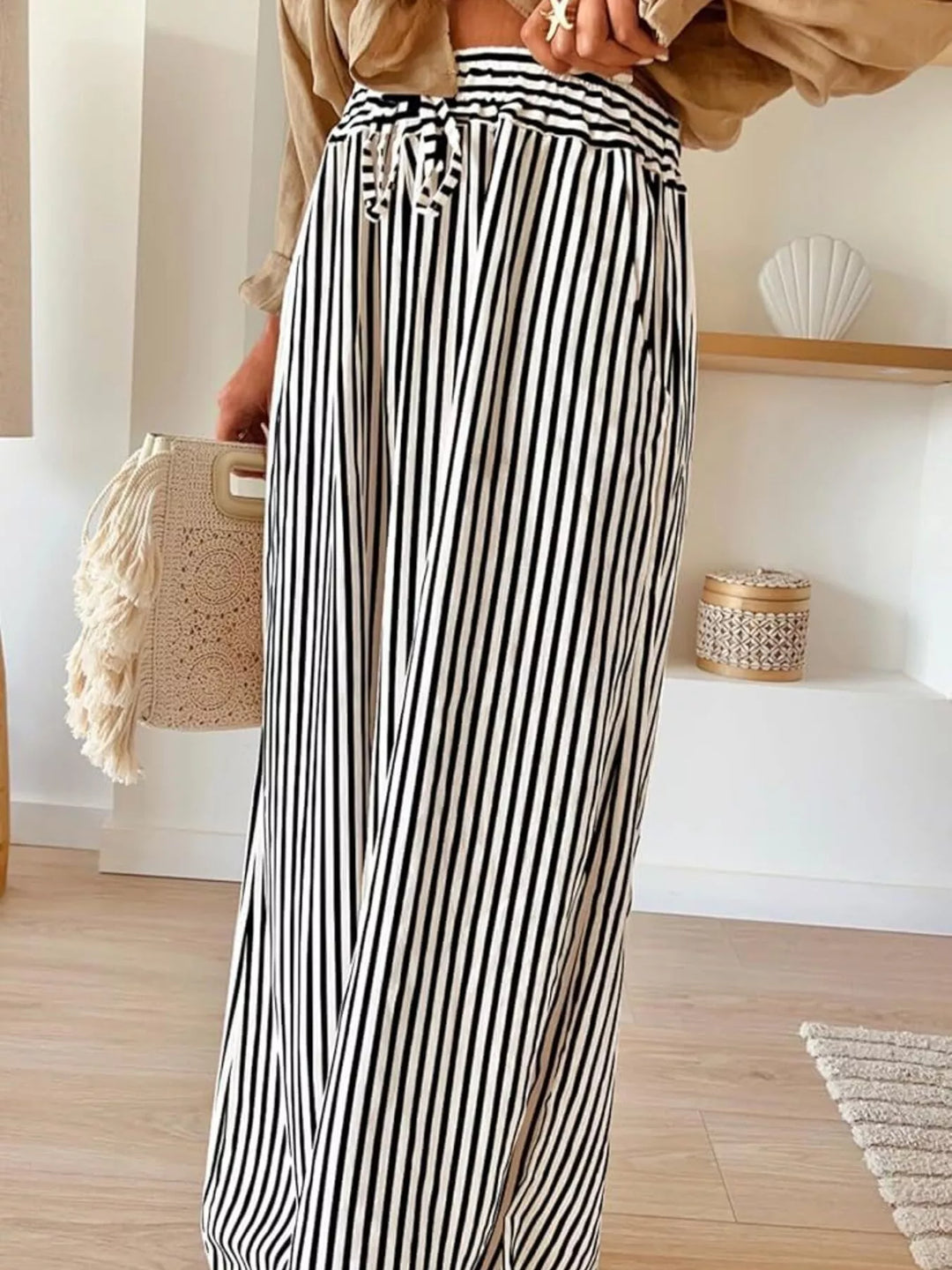 Black and white thin stripe wide leg pants with tie waist, front view