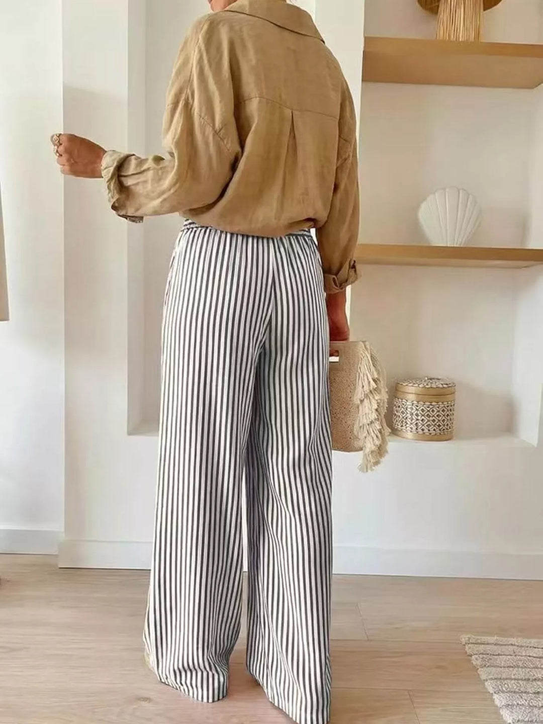 Back view of gray striped high waisted wide leg pants