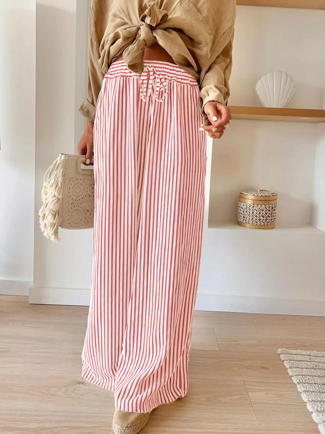 Pink thin stripe wide leg pants with drawstring waist and tan top