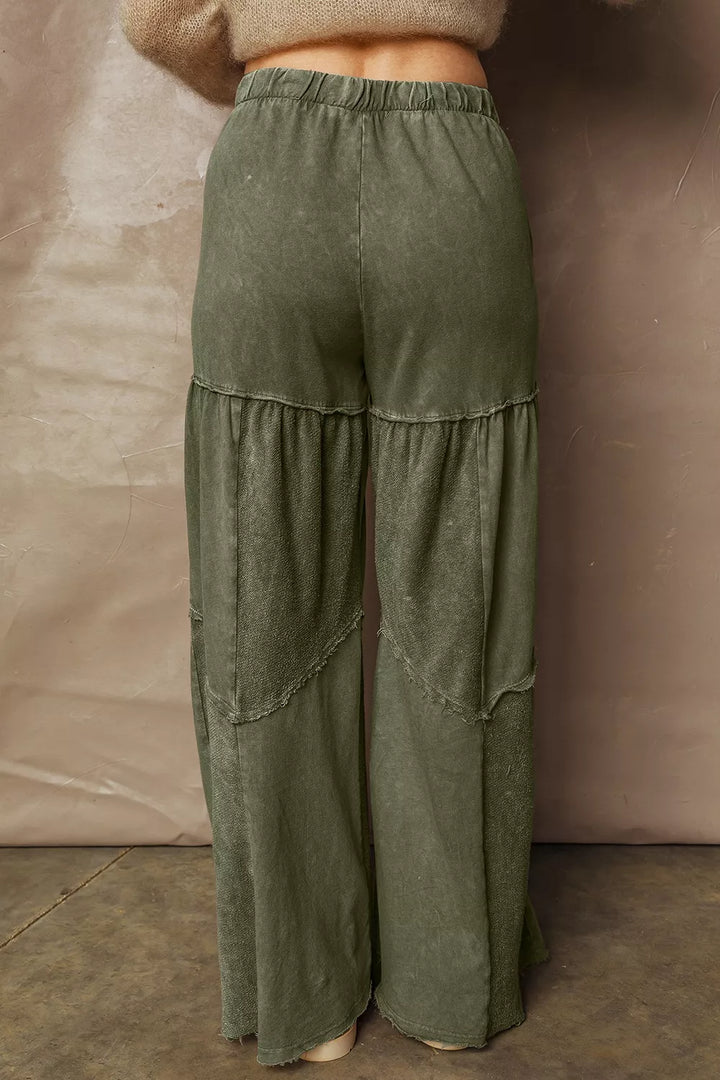 Back view of olive green tiered pants with an elastic waist