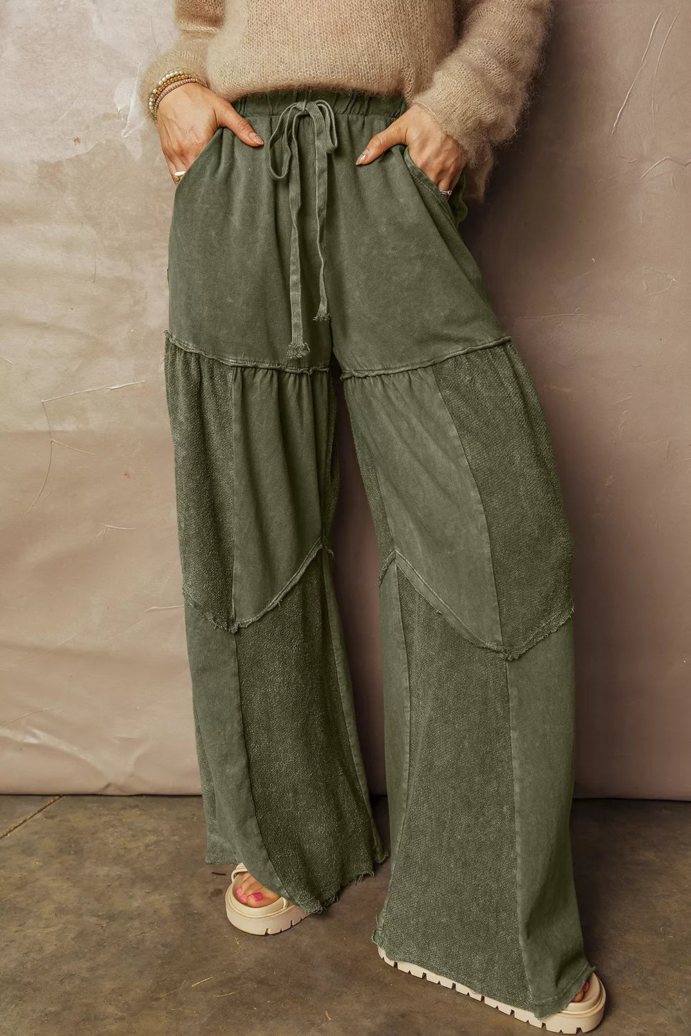 Women's wide leg pants in olive green, tiered with a drawstring waist and washed look